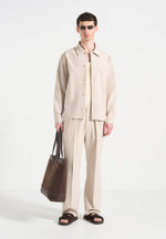 relaxed-fit-twin-pleat-pinstripe-trousers-beige