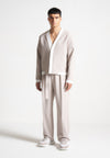 relaxed-fit-textured-belted-tailored-trousers-stone