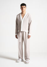 relaxed-fit-textured-belted-tailored-trousers-stone